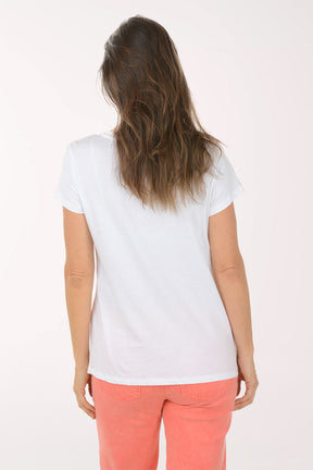 Woman wearing a white t-shirt with colorful graphic design on a white background