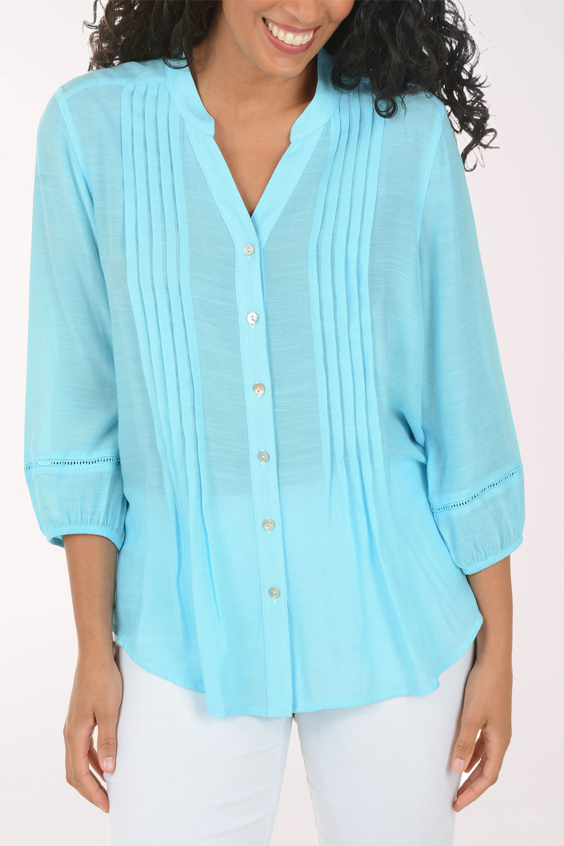 Woman wearing a light blue blouse with a white background