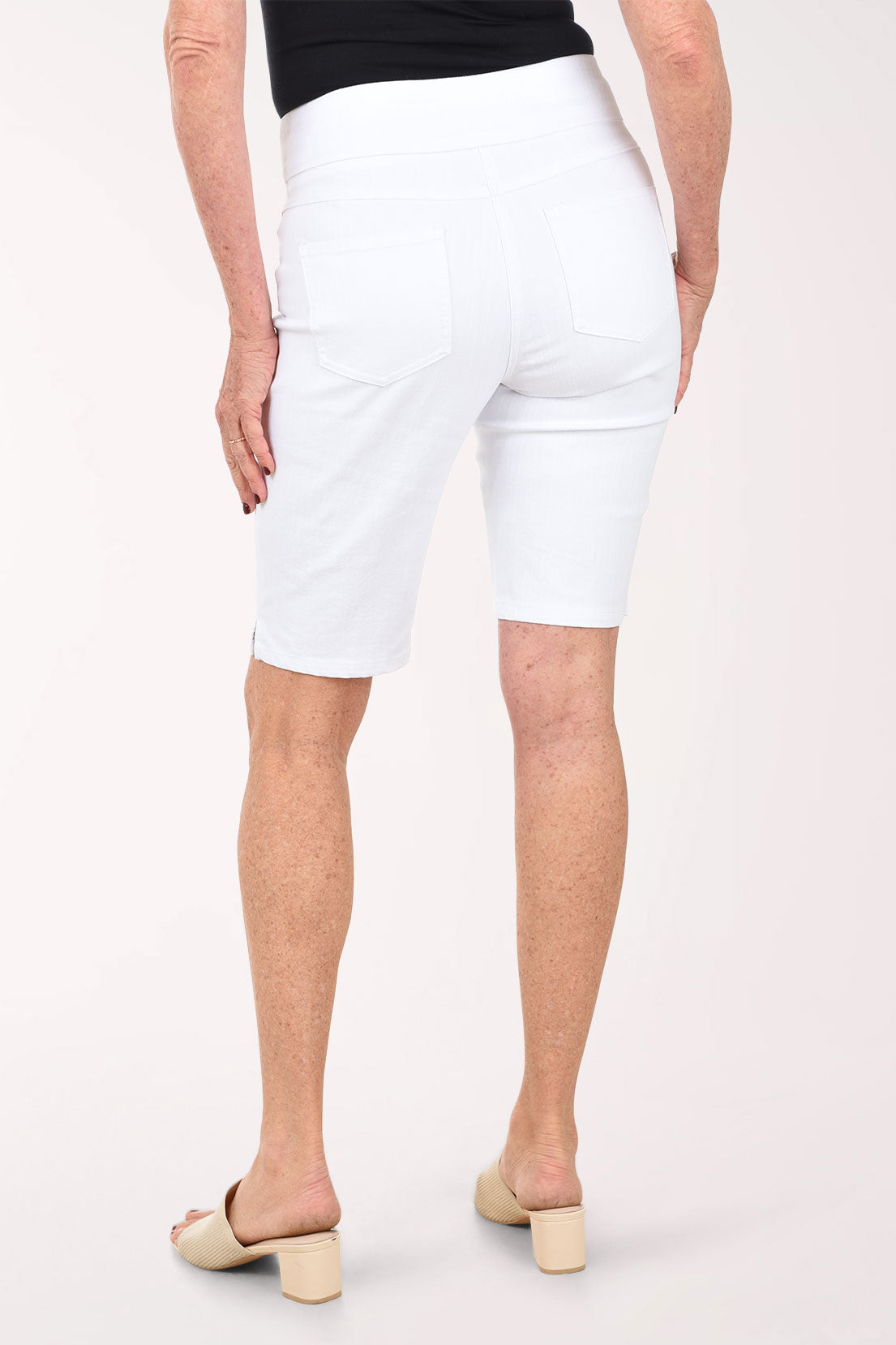White shorts worn by a person on a white background