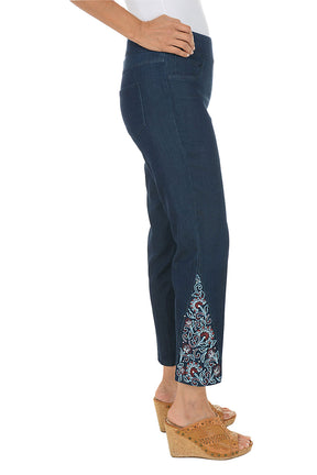Navy pants with floral embroidery on a white background. Side shot.