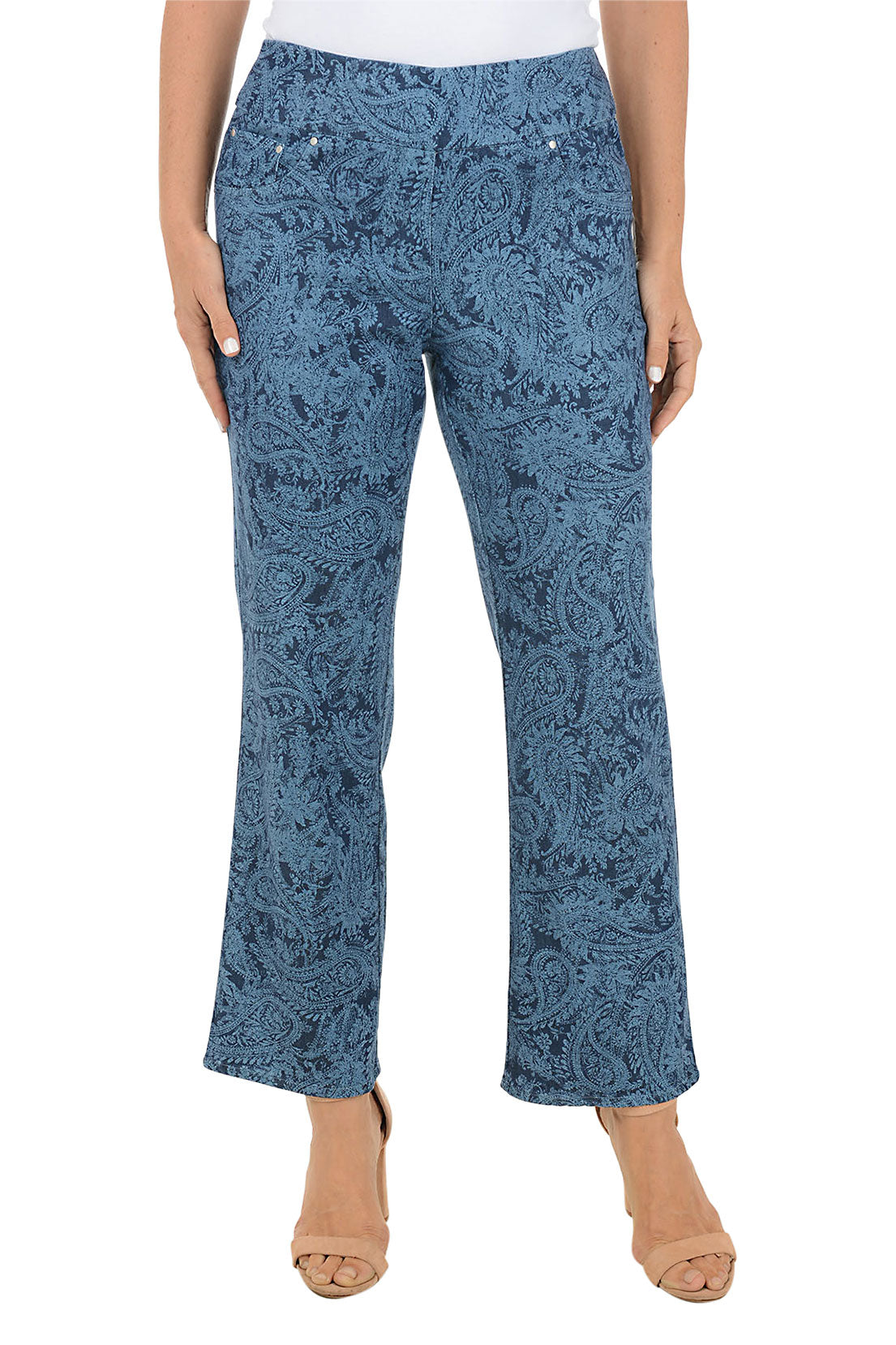 Blue denim paisley patterned ankle pants worn by a person on a white background.