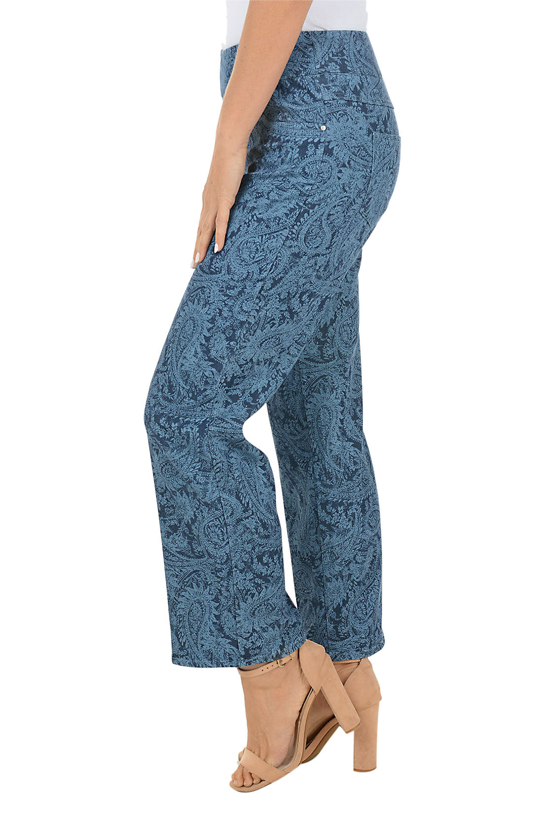 Blue denim paisley patterned ankle pants worn by a person on a white background. Side shot.