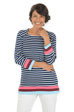 Woman wearing a navy and white striped long-sleeve top with colorful cuffs on a white background.