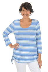 A front shot of a model wearing a chambray multi white striped sweater on a white background