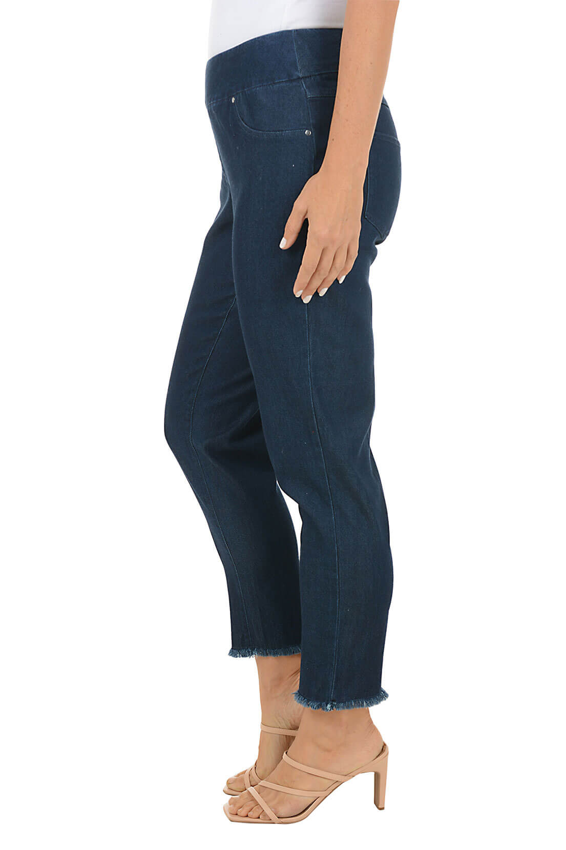 Person wearing dark blue jeans on a white background. Side shot.