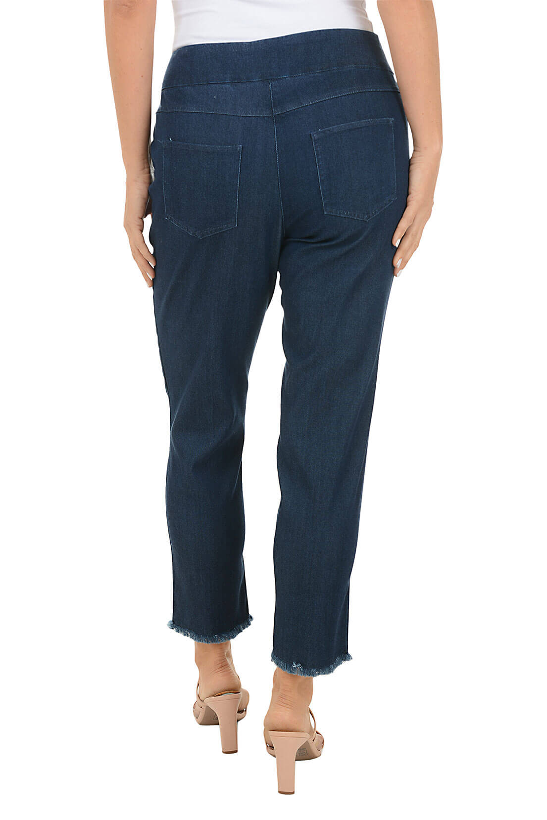 Person wearing dark blue jeans on a white background. Back shot.