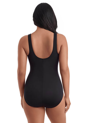 Black swimsuit worn by a model on a white background