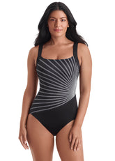 Woman wearing a black and white striped swimsuit on a white background