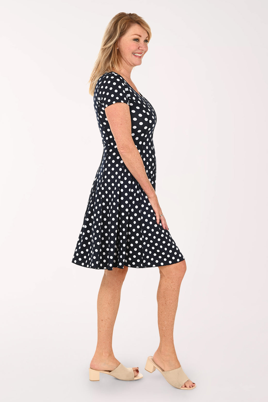 Woman wearing a short sleeve black and white polka dot dress 