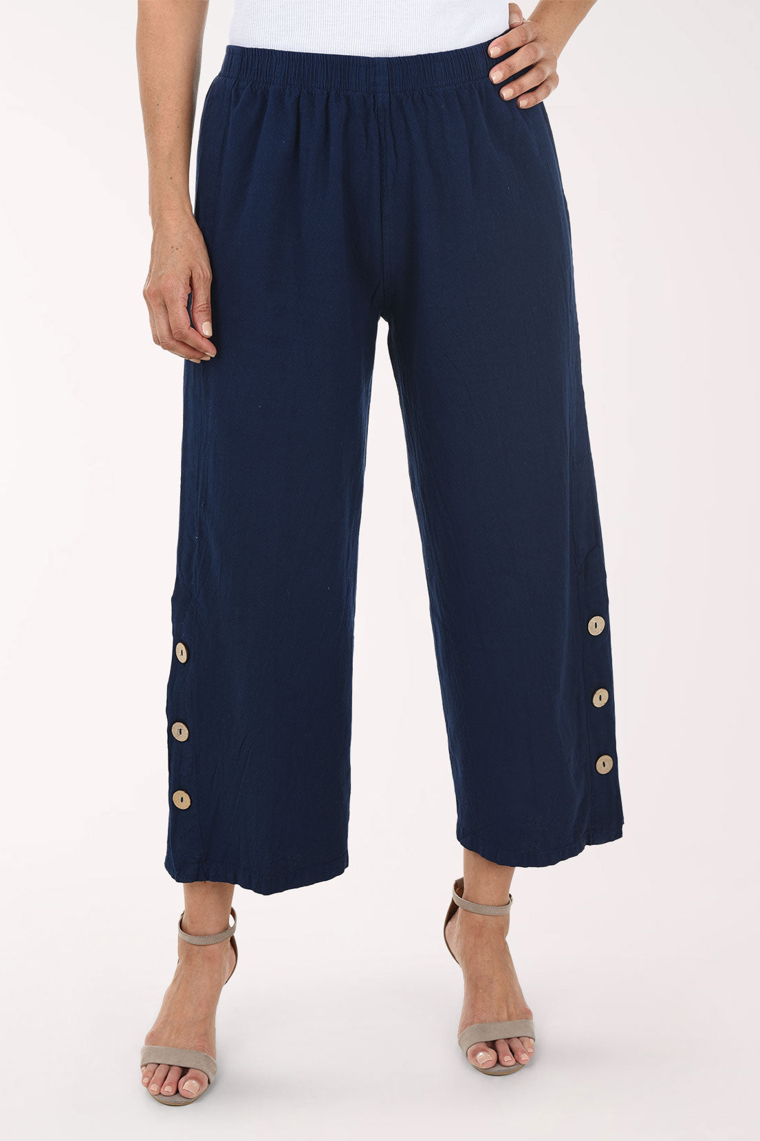 Navy blue pants with gold buttons on a white background