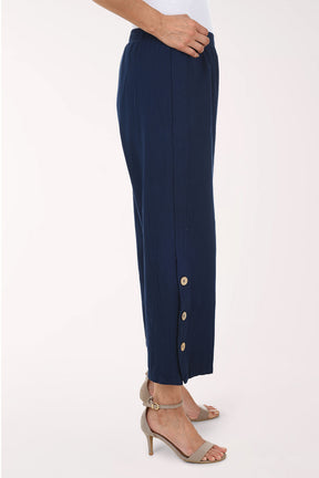 Navy blue pants with gold buttons on a white background