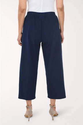 Navy blue pants with gold buttons on a white background