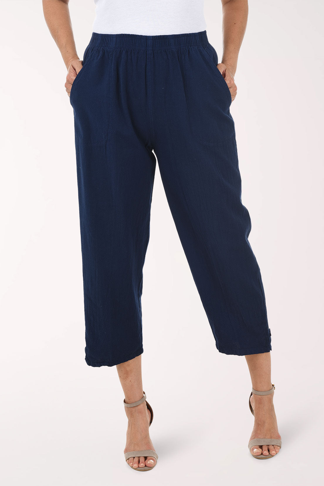 Navy blue pants worn by a person on a white background