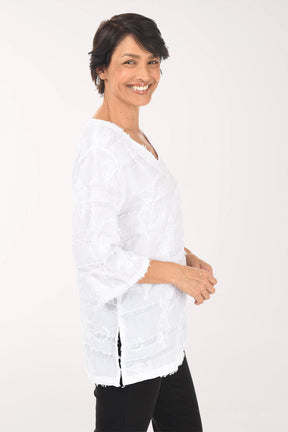 Woman wearing a white blouse with black pants on a white background