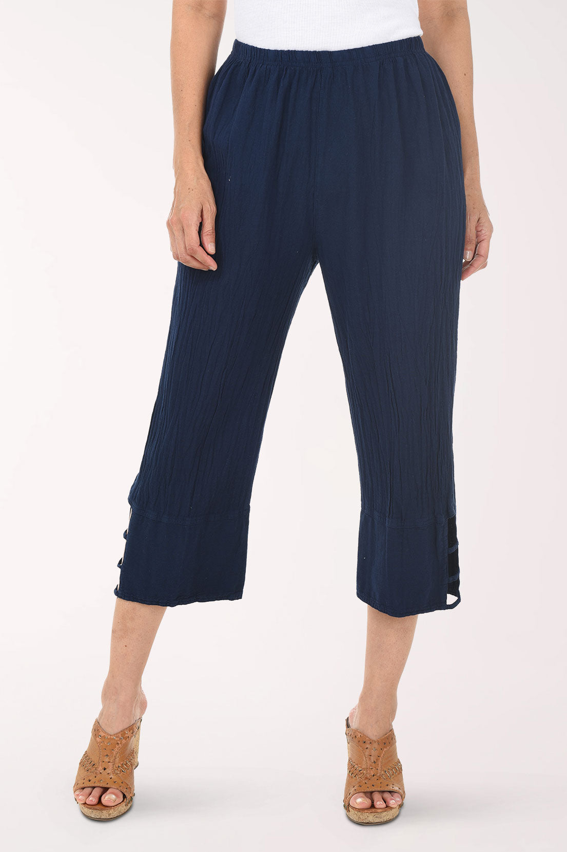 Navy ribbed pant with cut-out sides worn by a person on a white background