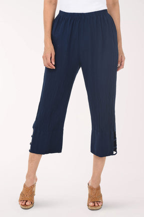 Navy ribbed pant with cut-out sides worn by a person on a white background