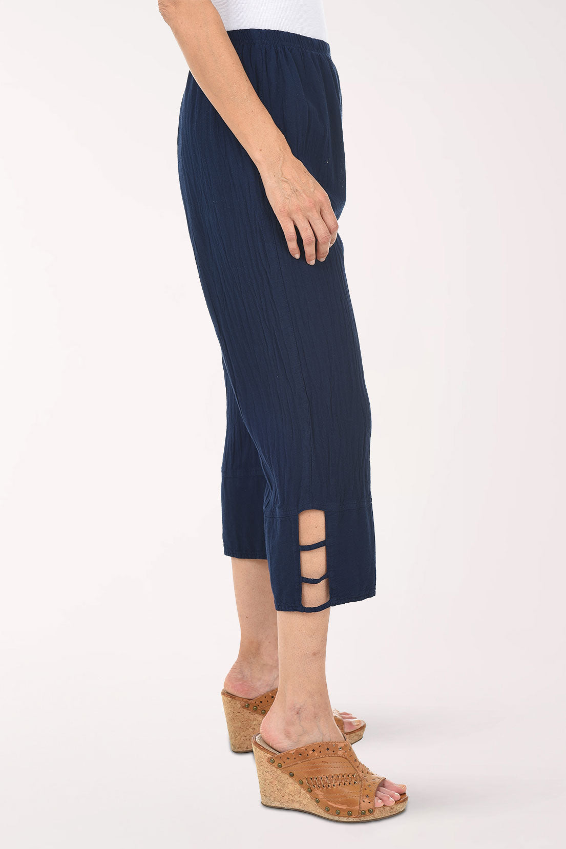 Navy ribbed pant with cut-out sides worn by a person on a white background