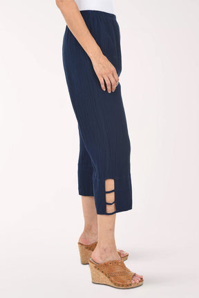 Navy ribbed pant with cut-out sides worn by a person on a white background