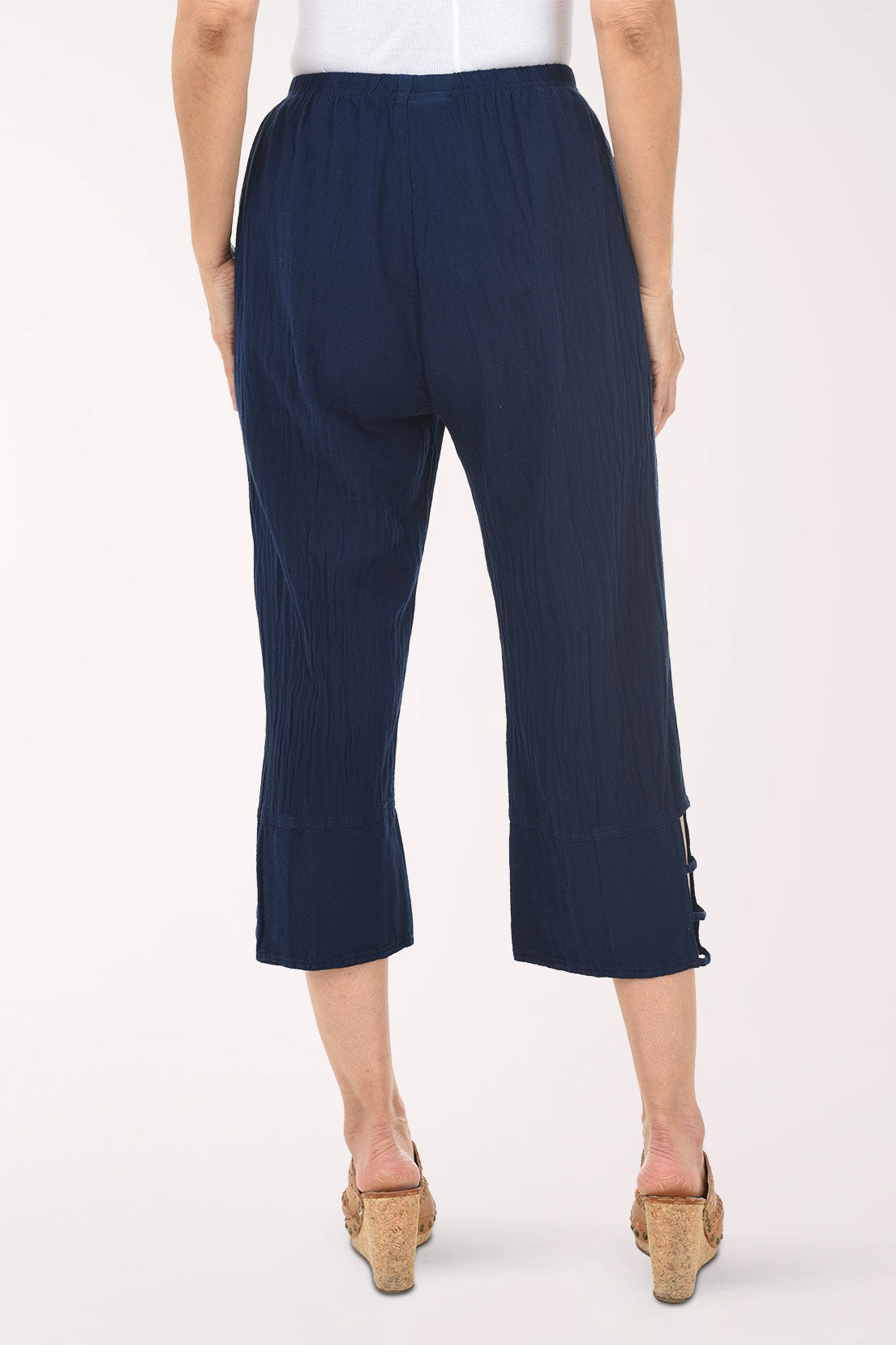 Navy ribbed pant with cut-out sides worn by a person on a white background