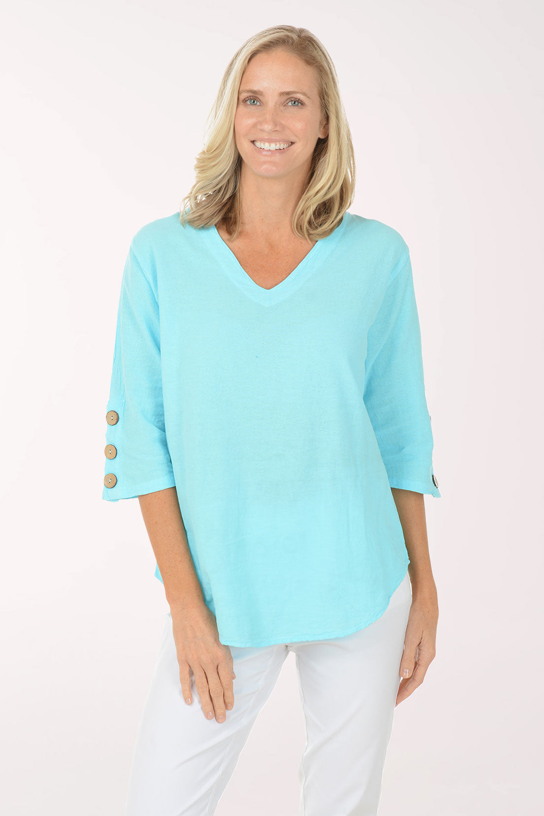 Woman wearing a light blue top with button details on a white background
