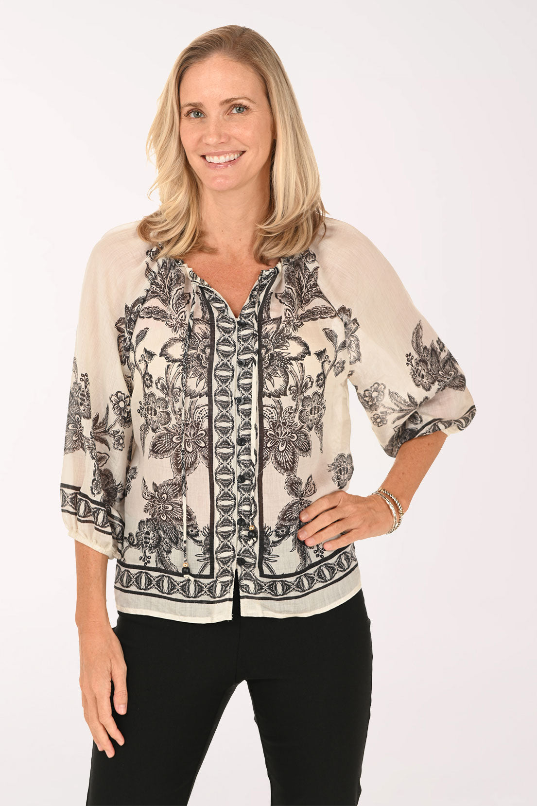 Woman wearing a patterned blouse with a white background