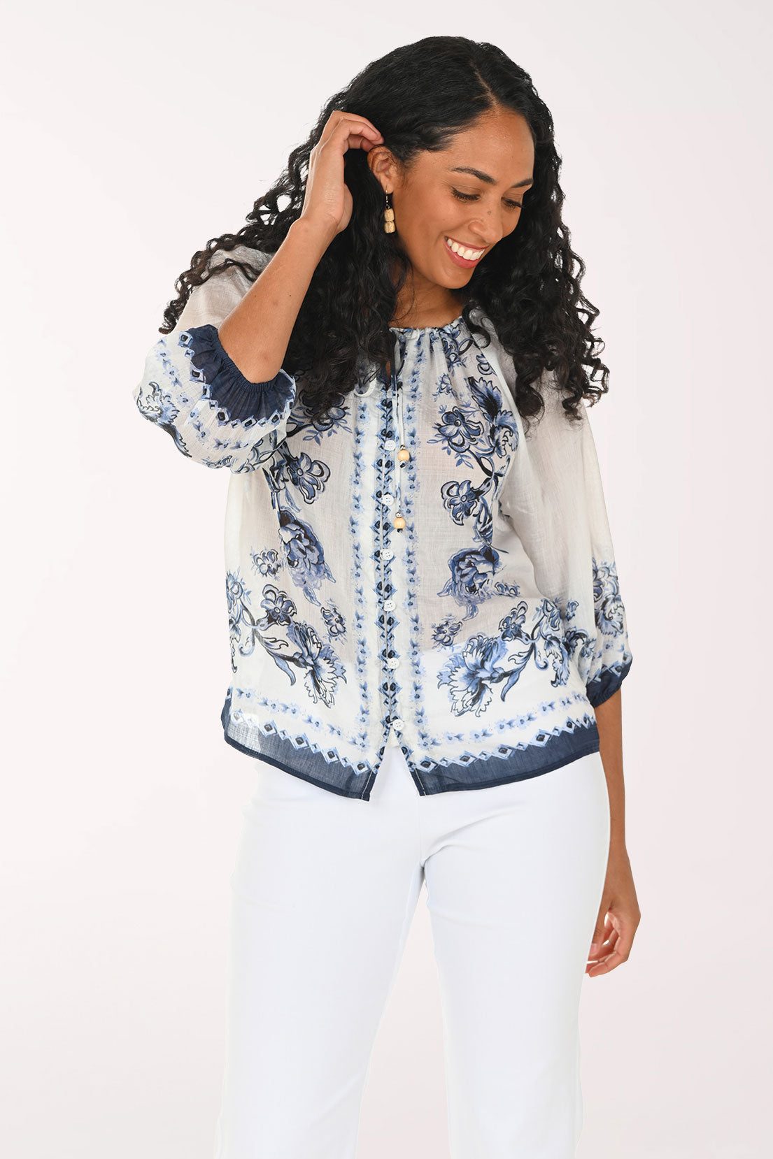 Woman wearing a floral blouse with a white background