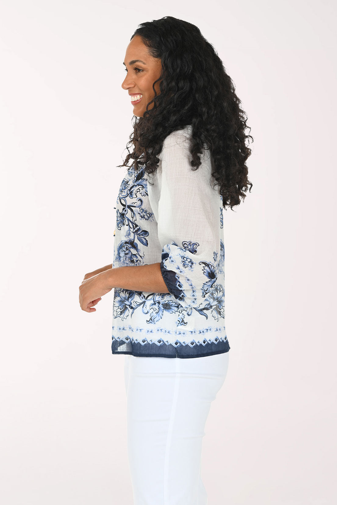 Woman wearing a floral blouse with a white background
