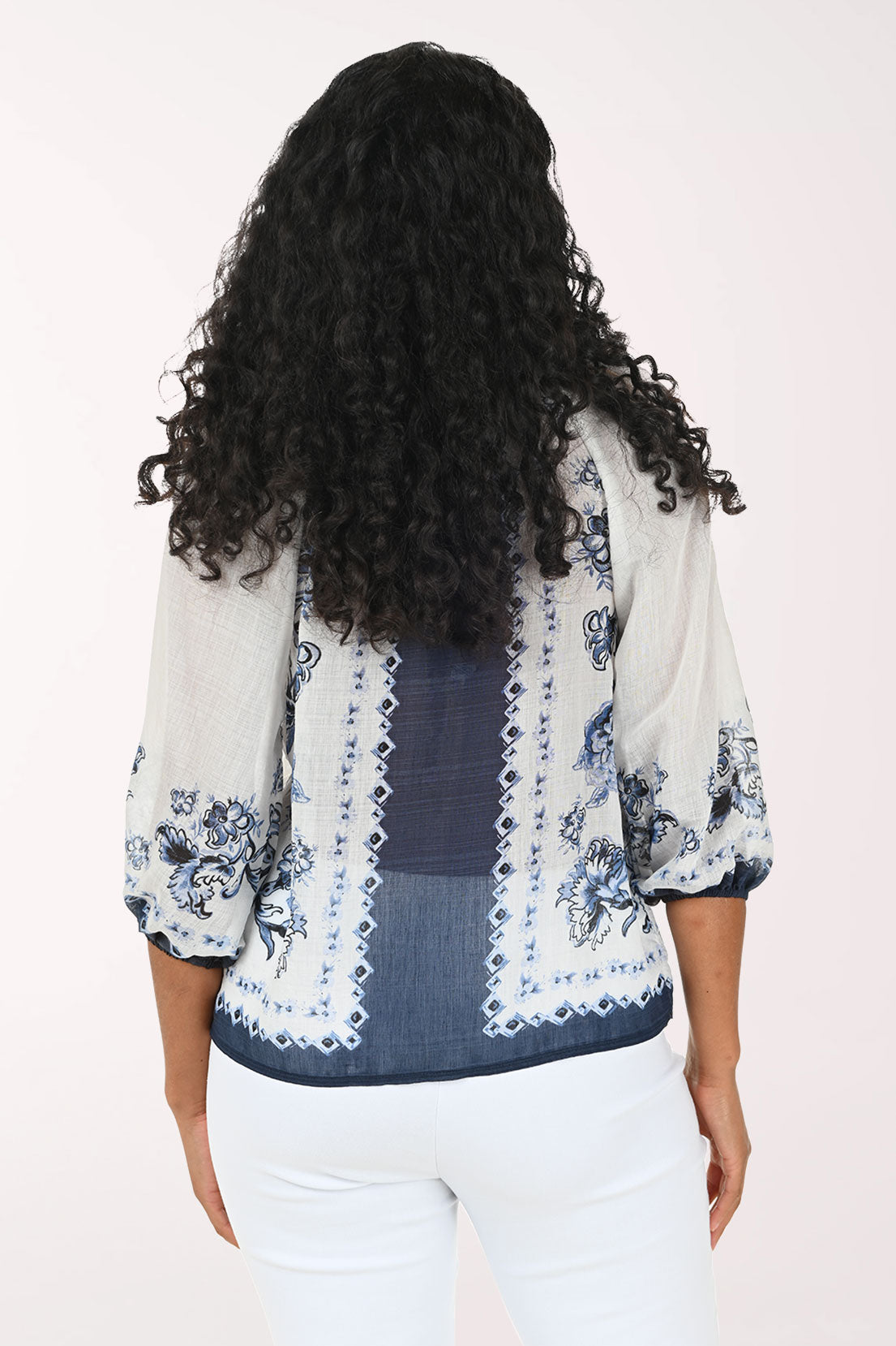 Woman wearing a floral blouse with a white background