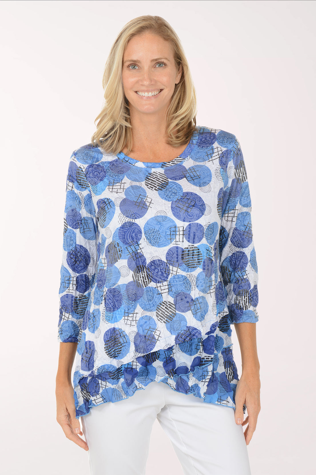 Woman wearing a blue patterned top on a white background
