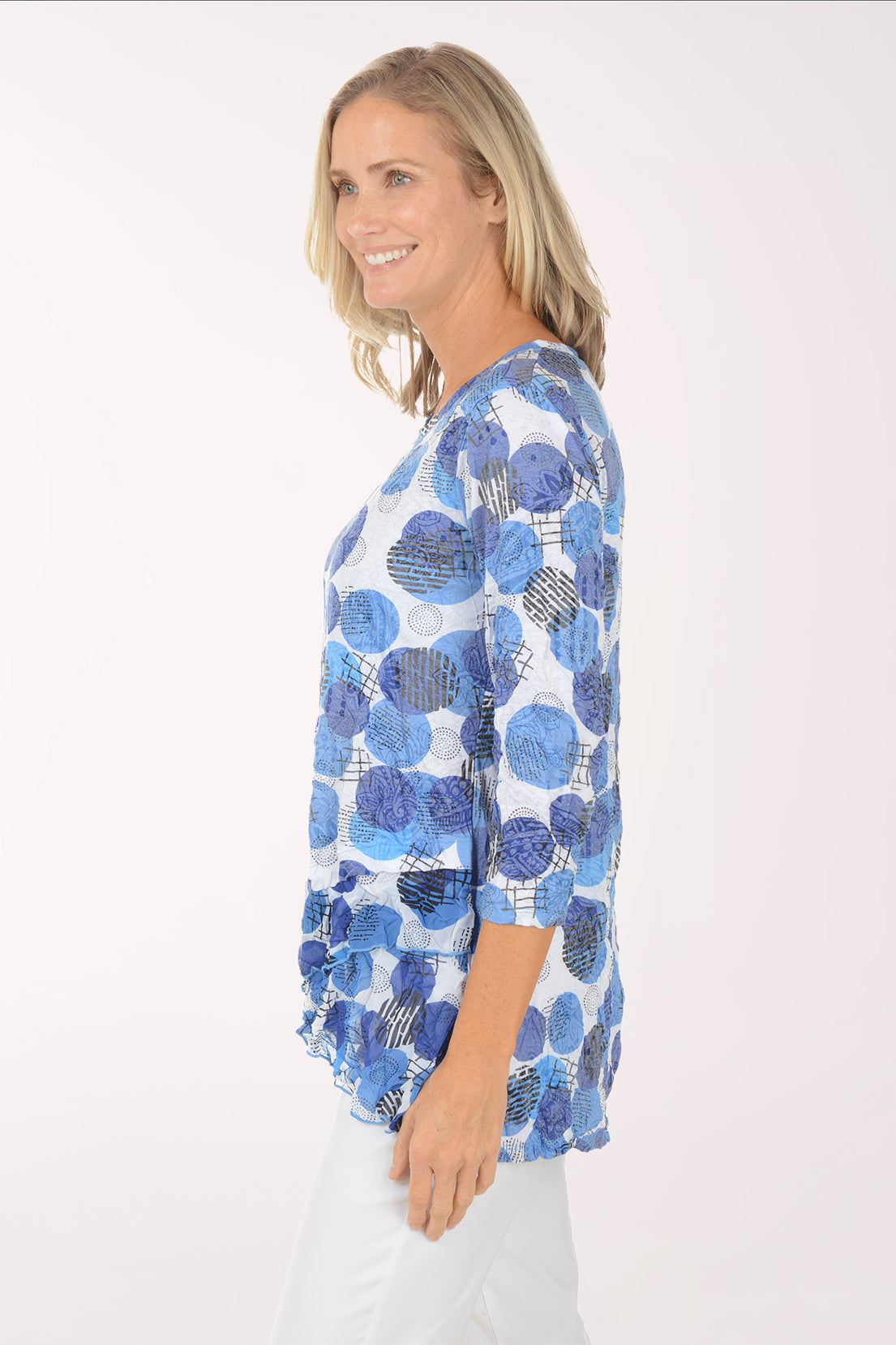 Woman wearing a blue patterned top on a white background