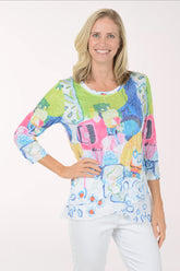 Woman wearing a colorful patterned top on a white background