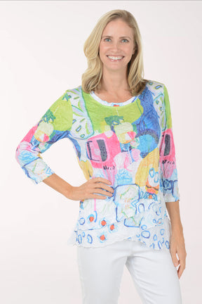 Woman wearing a colorful patterned top on a white background