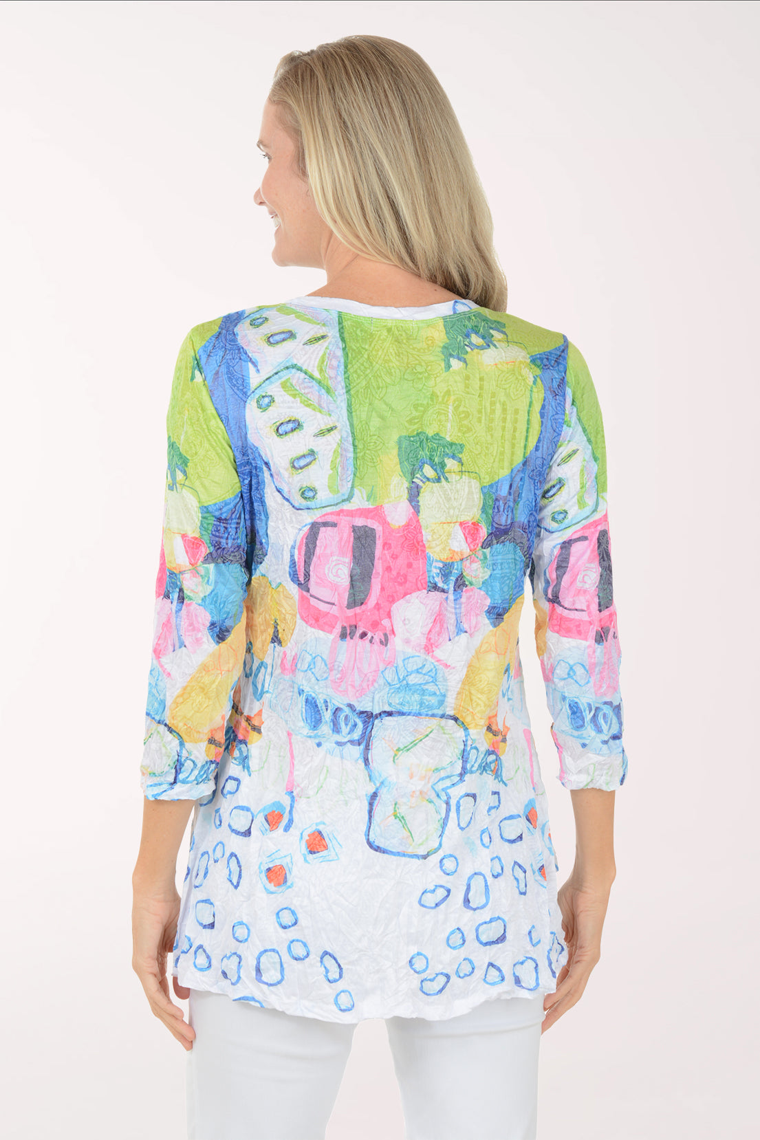 Woman wearing a colorful patterned top on a white background