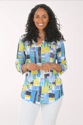 Woman wearing a colorful patterned shirt on a white background