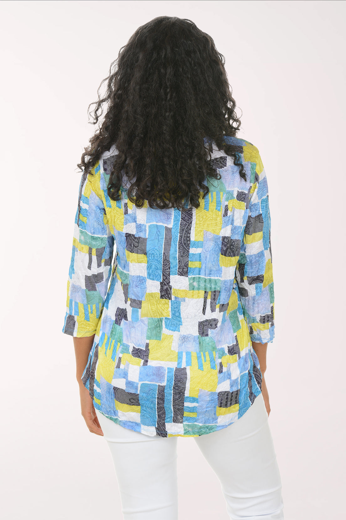 Woman wearing a colorful patterned shirt on a white background