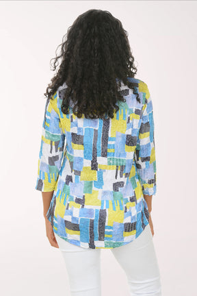 Woman wearing a colorful patterned shirt on a white background