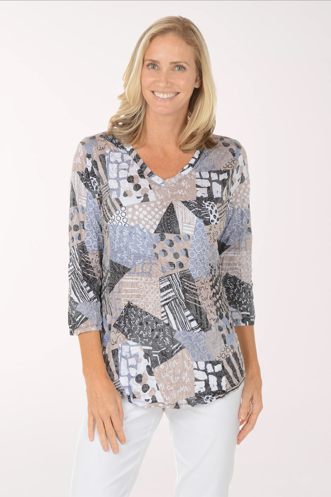 Woman wearing a patterned top on a white background