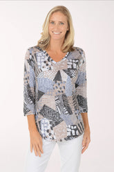 Woman wearing a patterned top on a white background