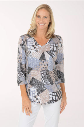 Woman wearing a patterned top on a white background