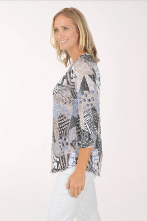 Woman wearing a patterned top on a white background