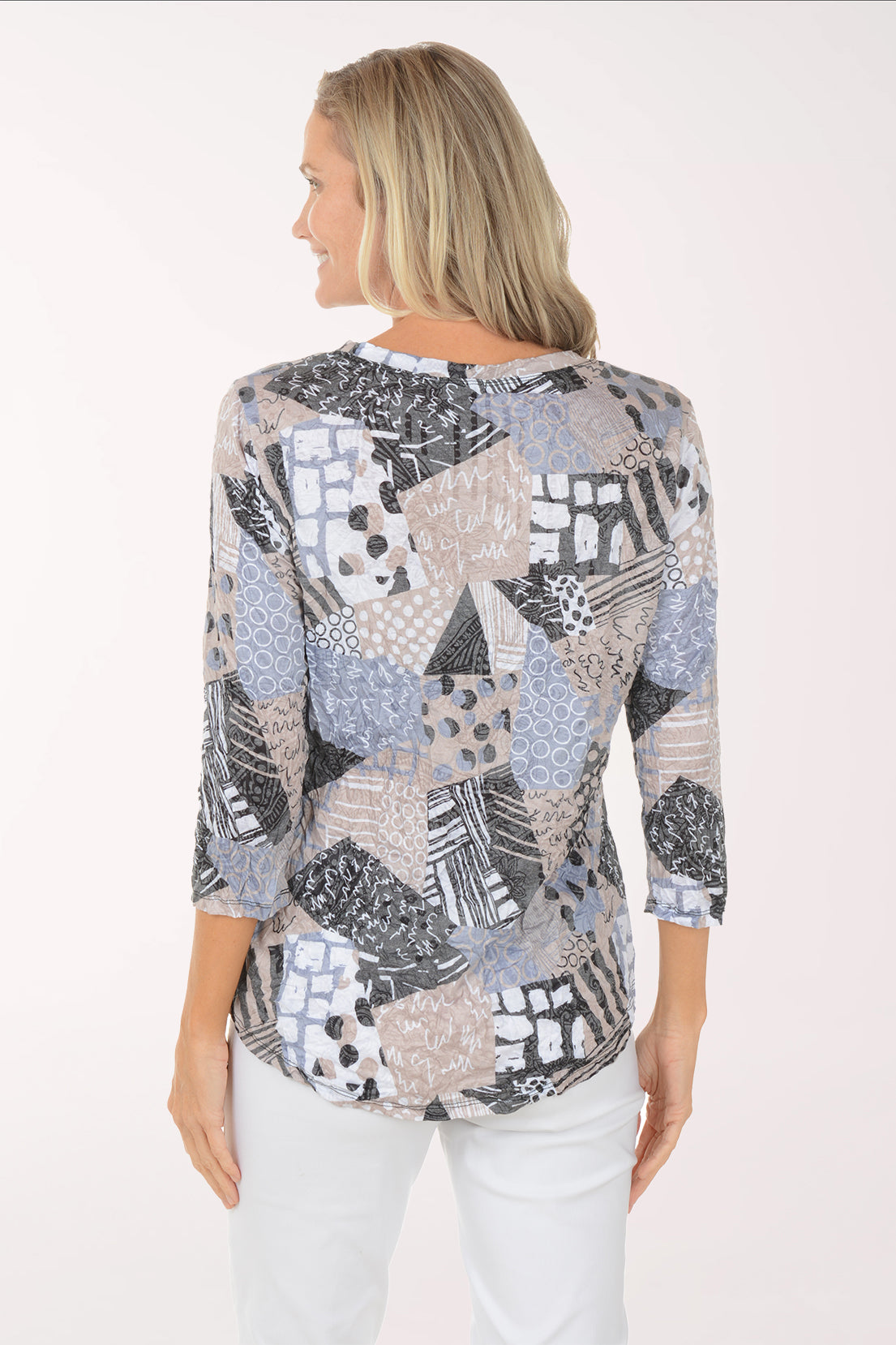 Woman wearing a patterned top on a white background