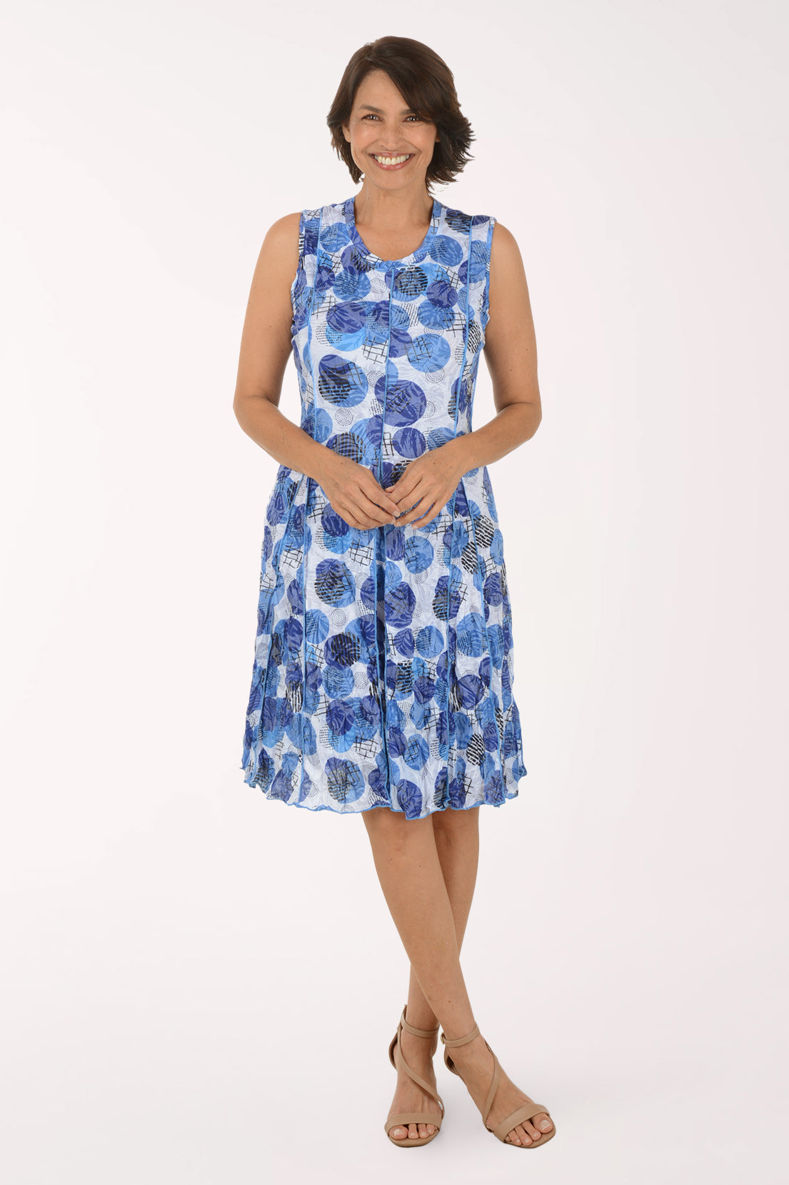 Woman wearing a blue floral dress on a white background