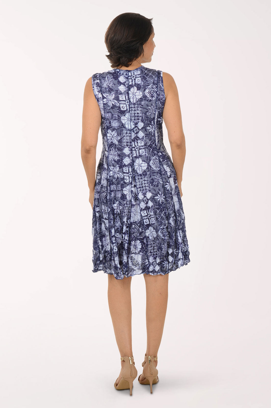 Woman wearing a blue floral dress on a white background