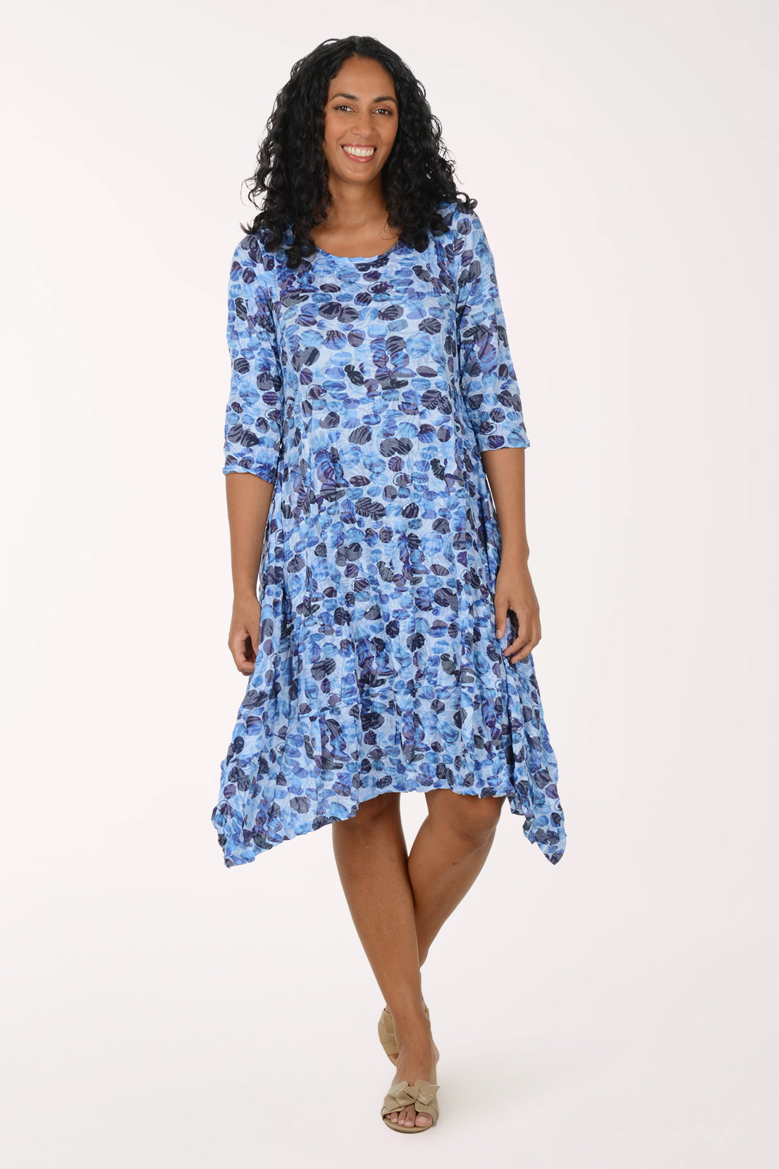 Woman wearing a blue floral dress on a white background
