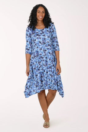 Woman wearing a blue floral dress on a white background