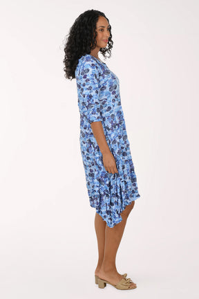 Woman wearing a blue floral dress on a white background