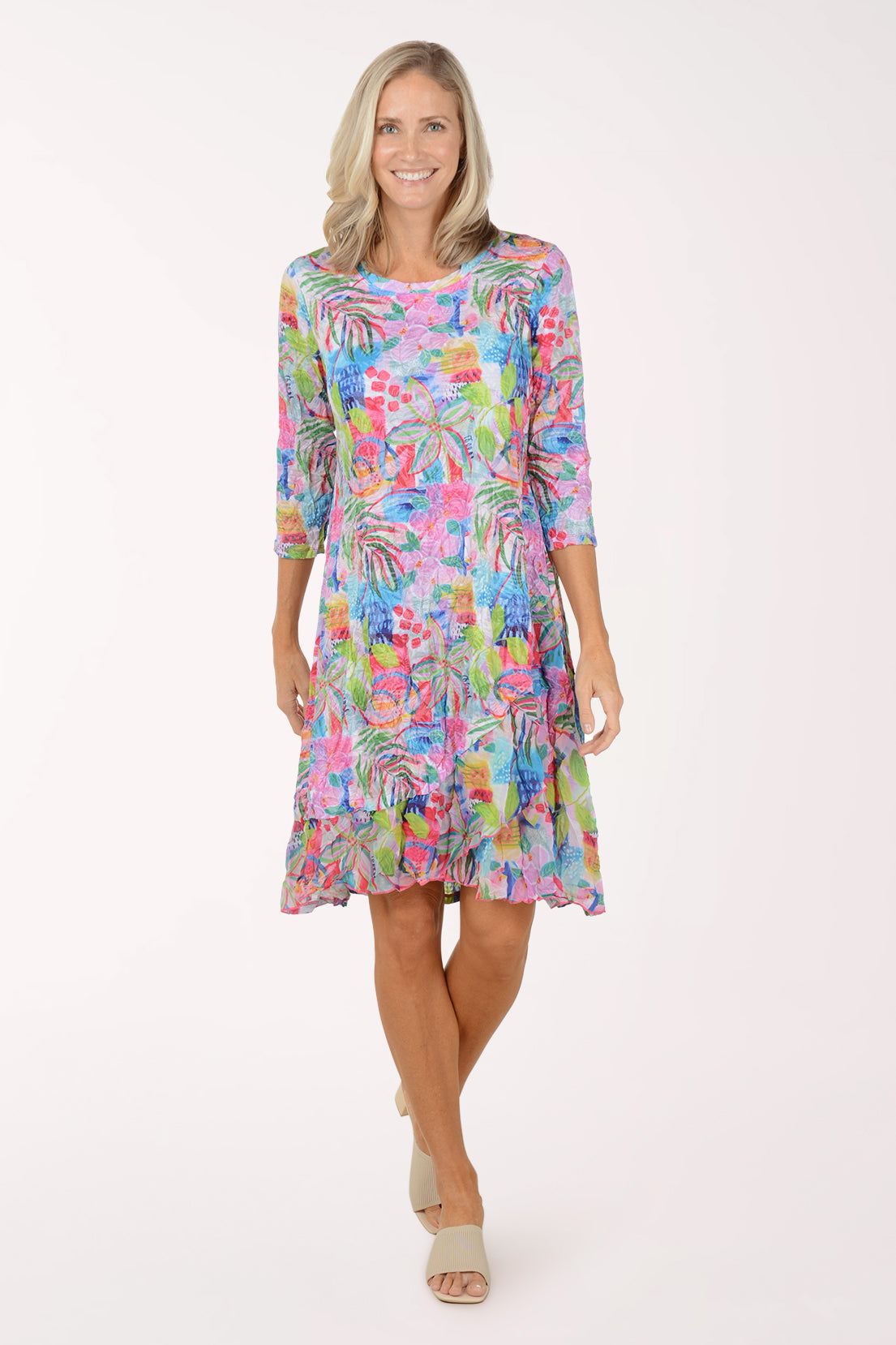 Woman wearing a colorful floral dress on a white background