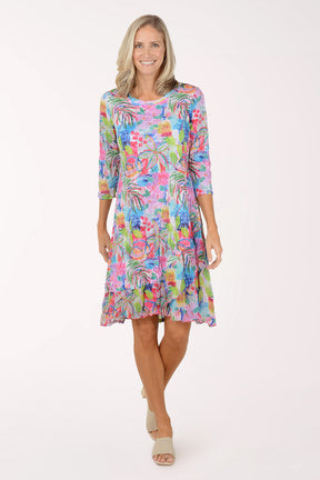 Woman wearing a colorful floral dress on a white background