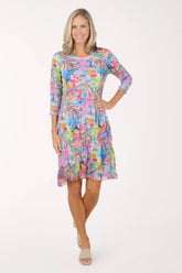 Woman wearing a colorful floral dress on a white background