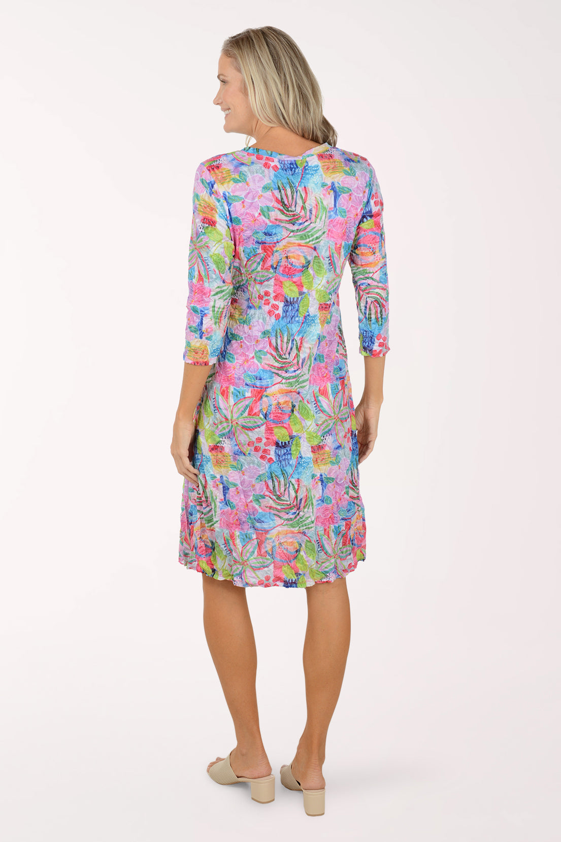Woman wearing a colorful floral dress on a white background